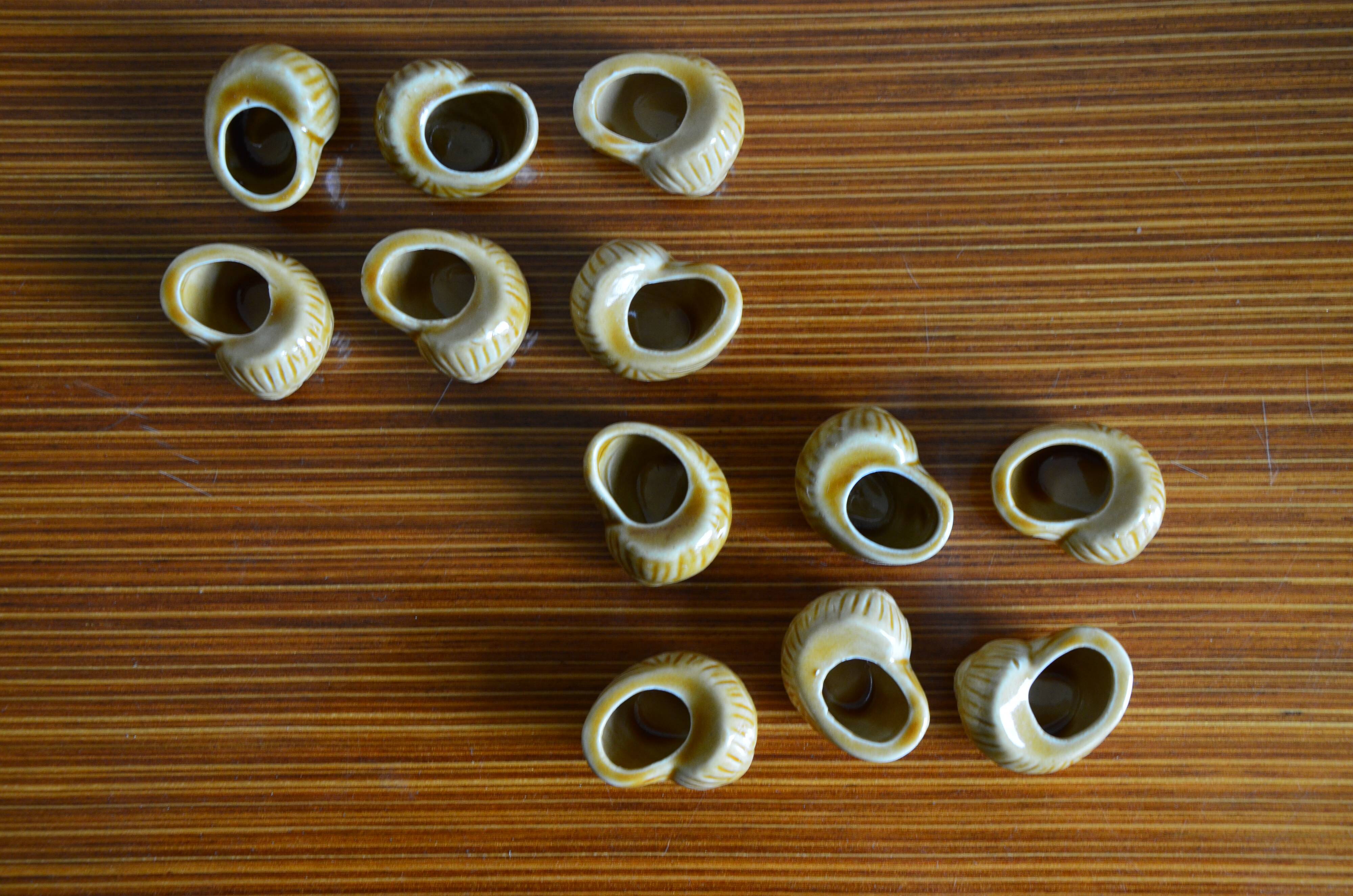 Lot of 12 enamelled sandstone snail shells