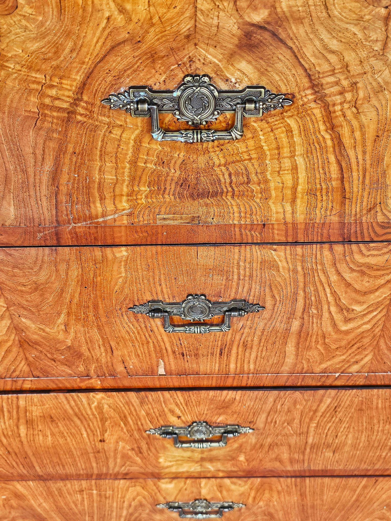 Large antique Biedermeier-style chest of drawers with wood grain.
