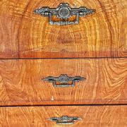 Large antique Biedermeier-style chest of drawers with wood grain.