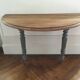 Antique painted wooden half-moon console table