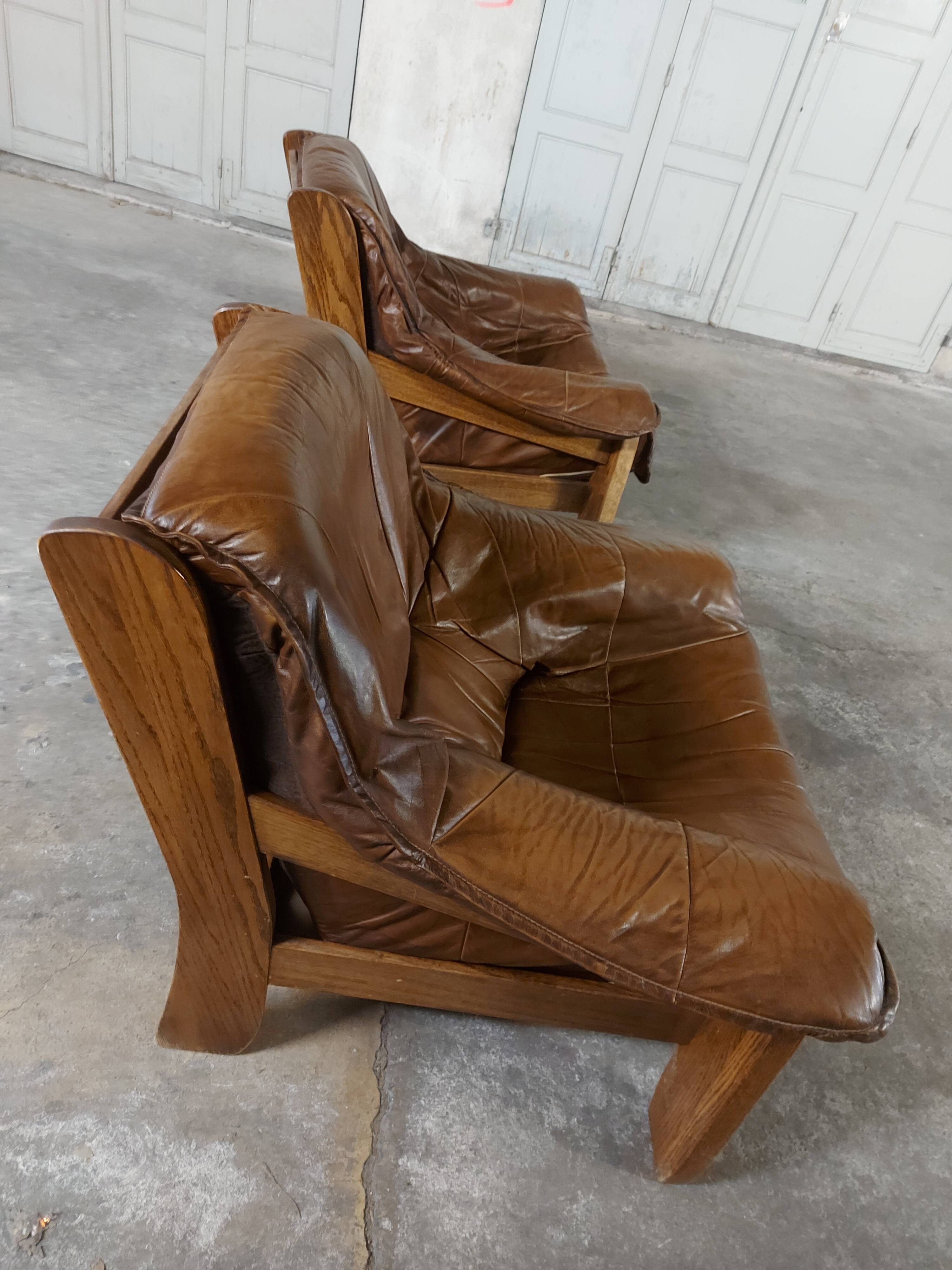 Armchairs in leather and vintage wood 70's