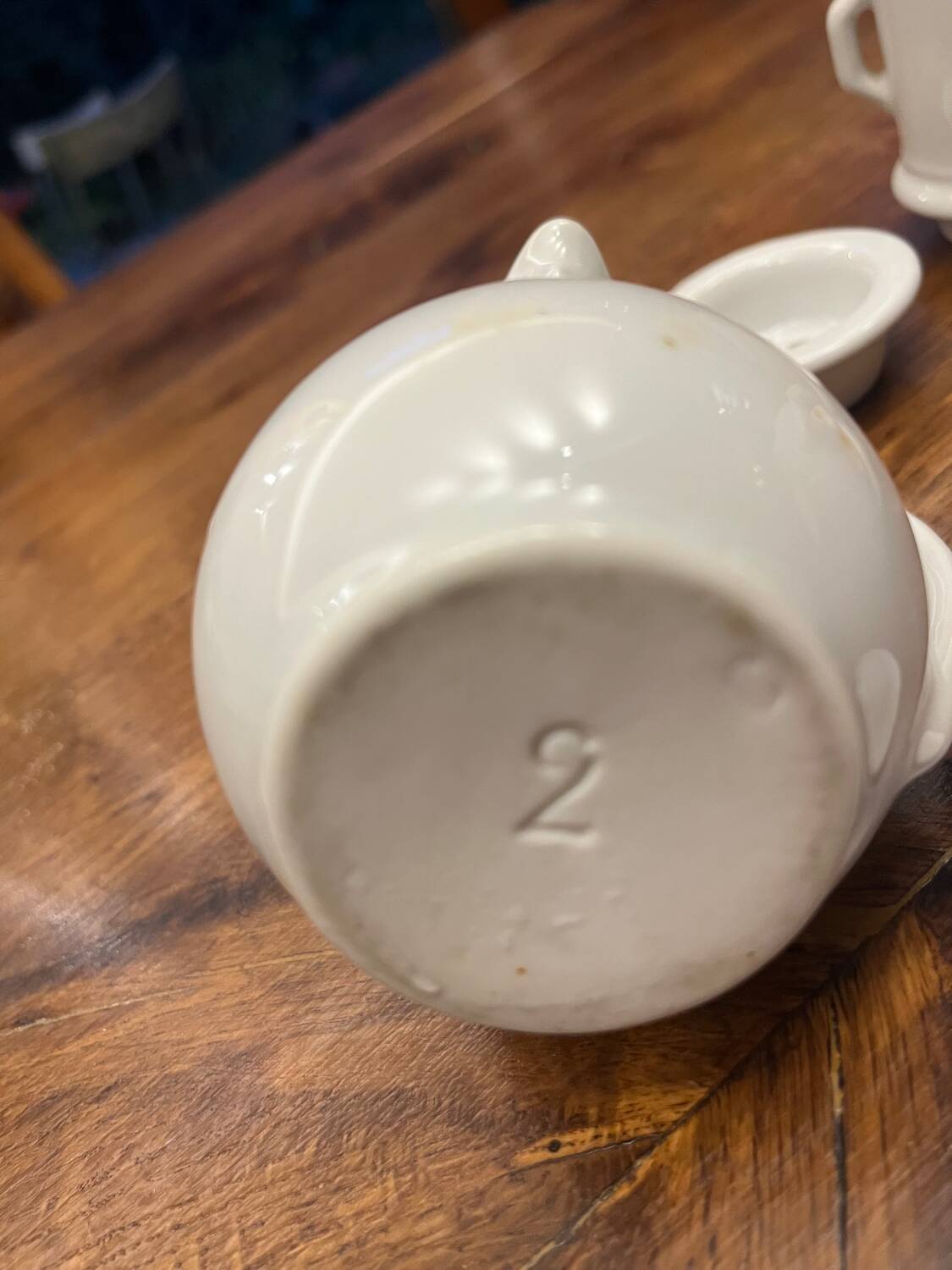 Antique white earthenware teapot, individual service with filter.