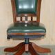 Modern captain's chair in leather, beech frame, adjustable.