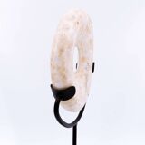 "Wamayuwa" Boiken coin in hand-carved shell mounted on a black metal stand