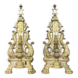 pair of Empire period dolphin firedogs in gilded bronze