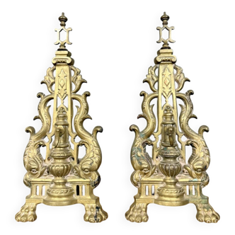 pair of Empire period dolphin firedogs in gilded bronze
