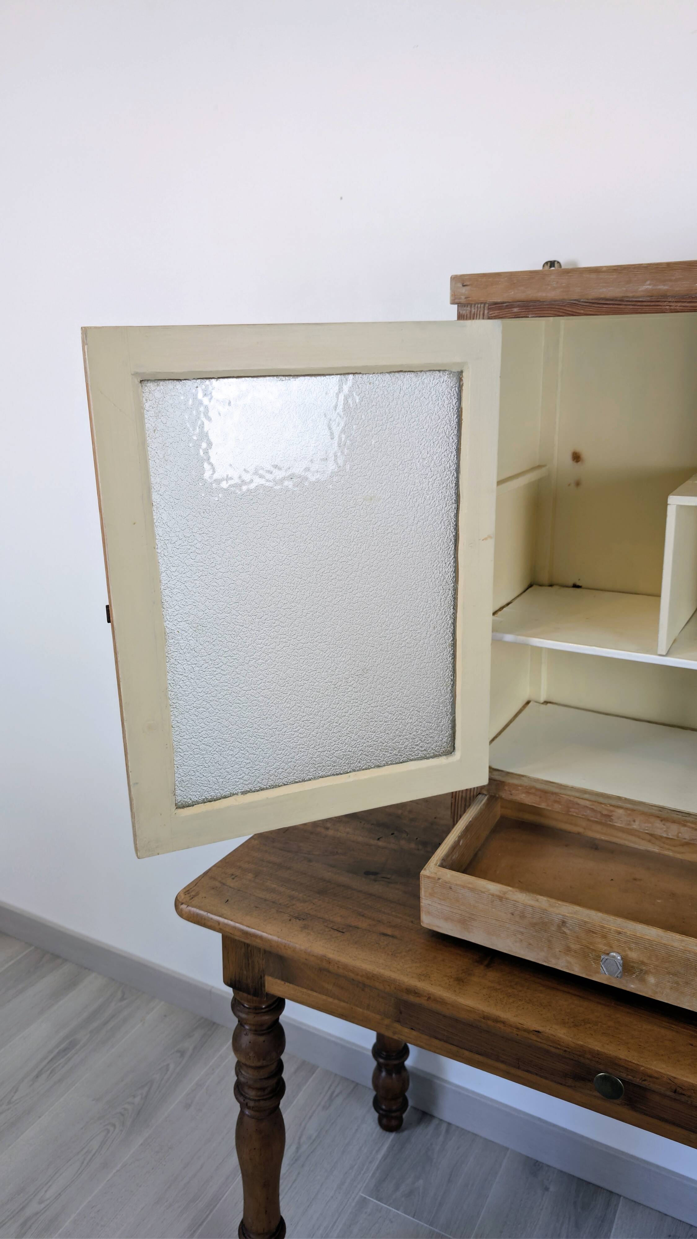 Small glass wall cabinet from the 1960s.