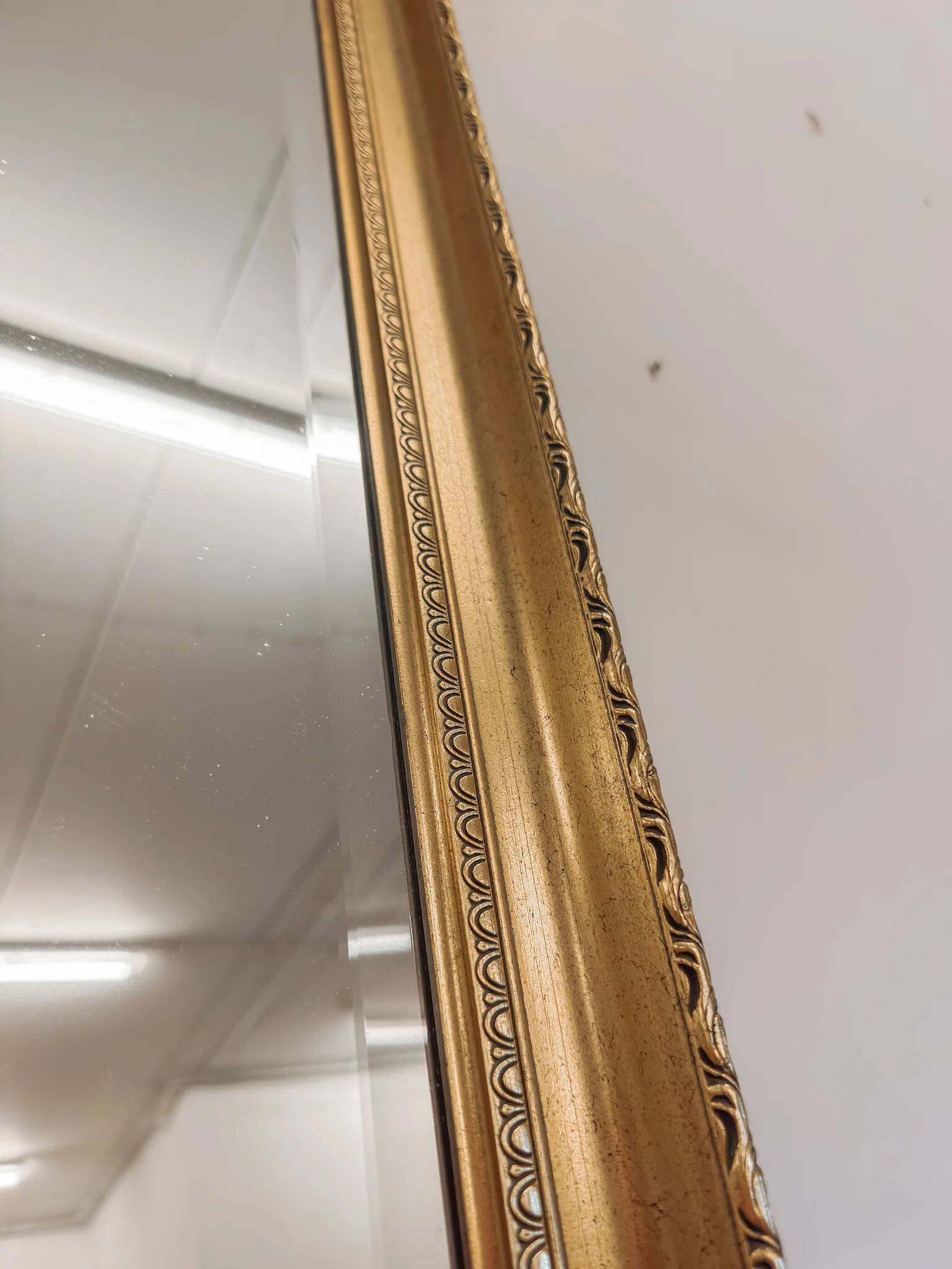 XL vintage bevelled mirror with a gold frame.