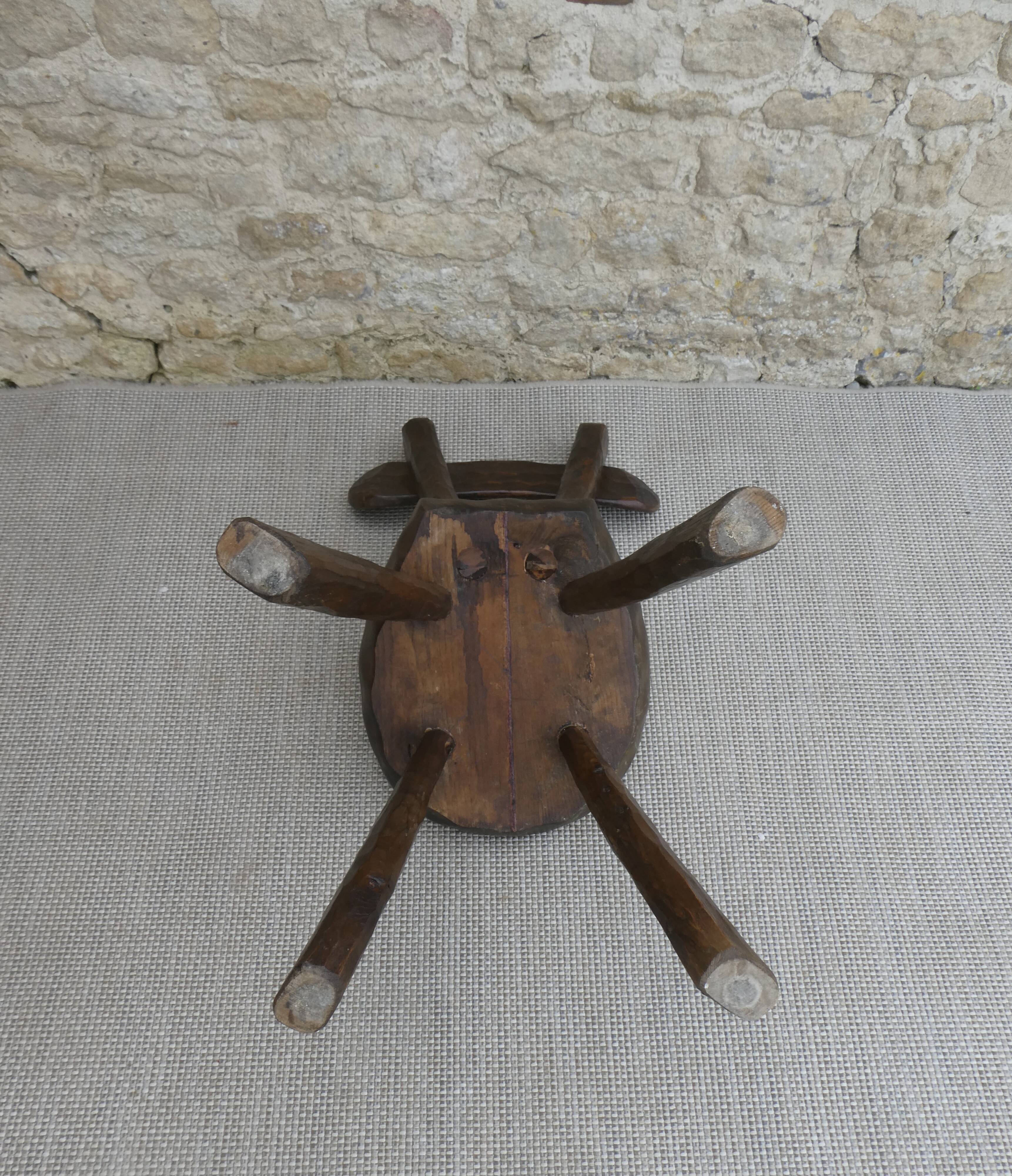 Brutalist chair in carved solid wood, around 1950.