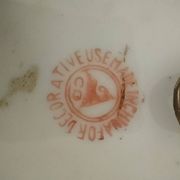 A pair of vintage Chinese decorative plates with floral designs on a yellow background.