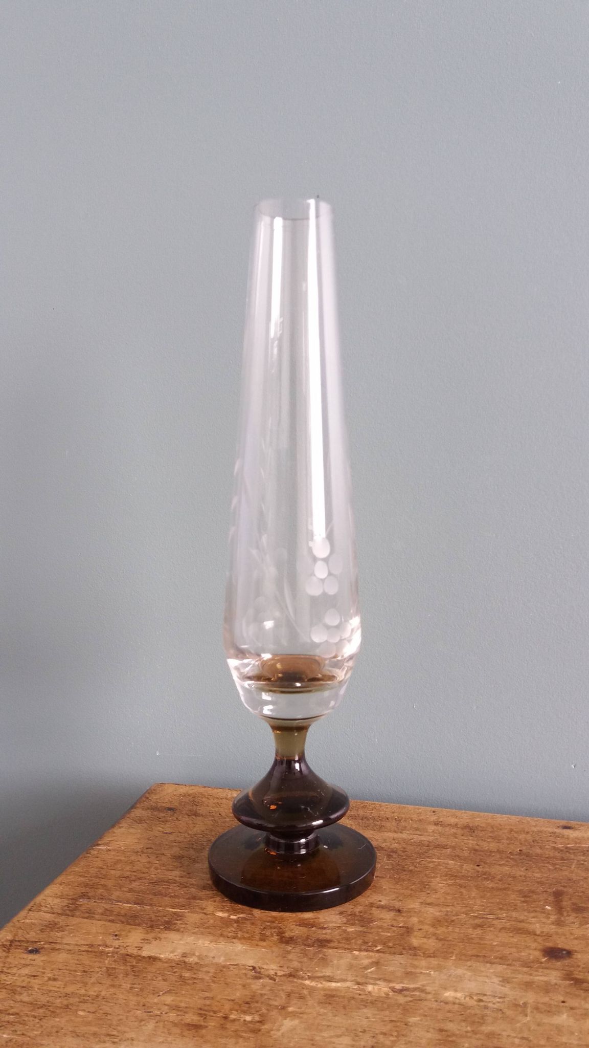 Cut glass soliflore vase with a smoked glass base.