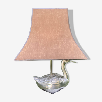 Old vintage lamp representing a duck in silver metal with wooden base