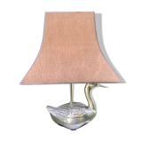 Old vintage lamp representing a duck in silver metal with wooden base