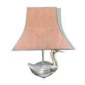 Old vintage lamp representing a duck in silver metal with wooden base