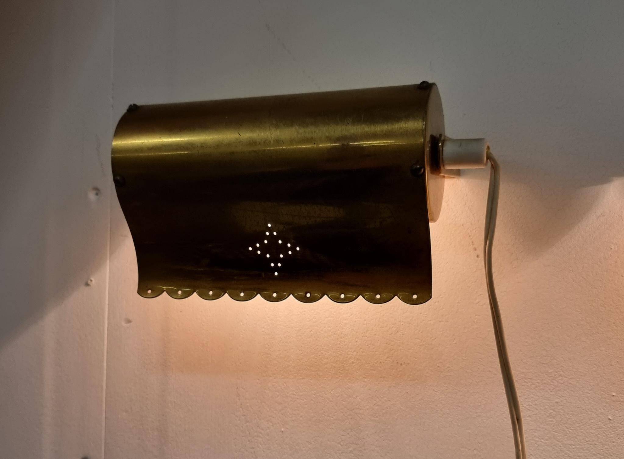A pair of charming wall sconces/branches in brass with a star pattern, modern Scandinavian style.