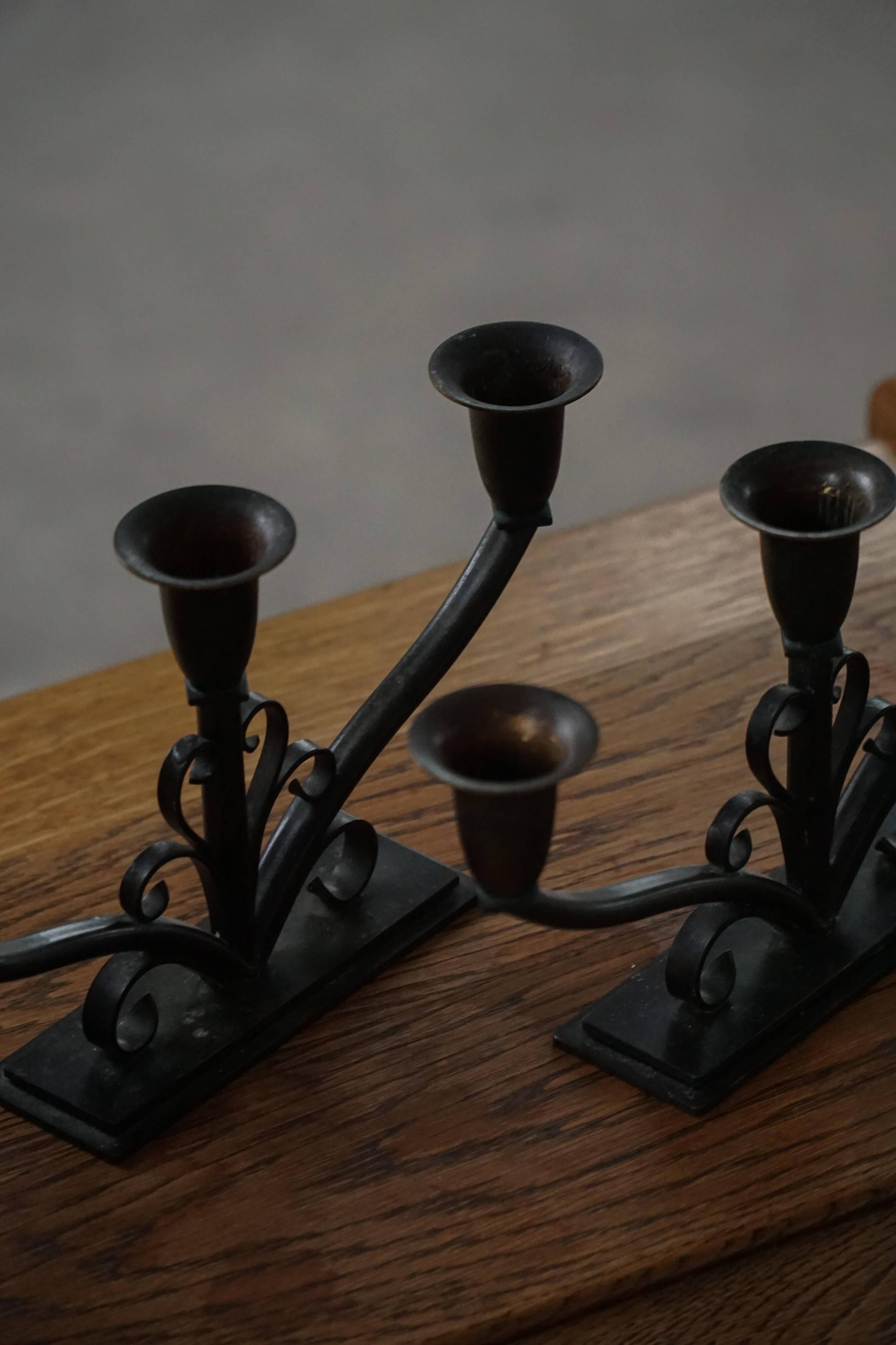 Early 20th century, pair of Danish Art Deco candlesticks in metal with three arms, 1930s.
