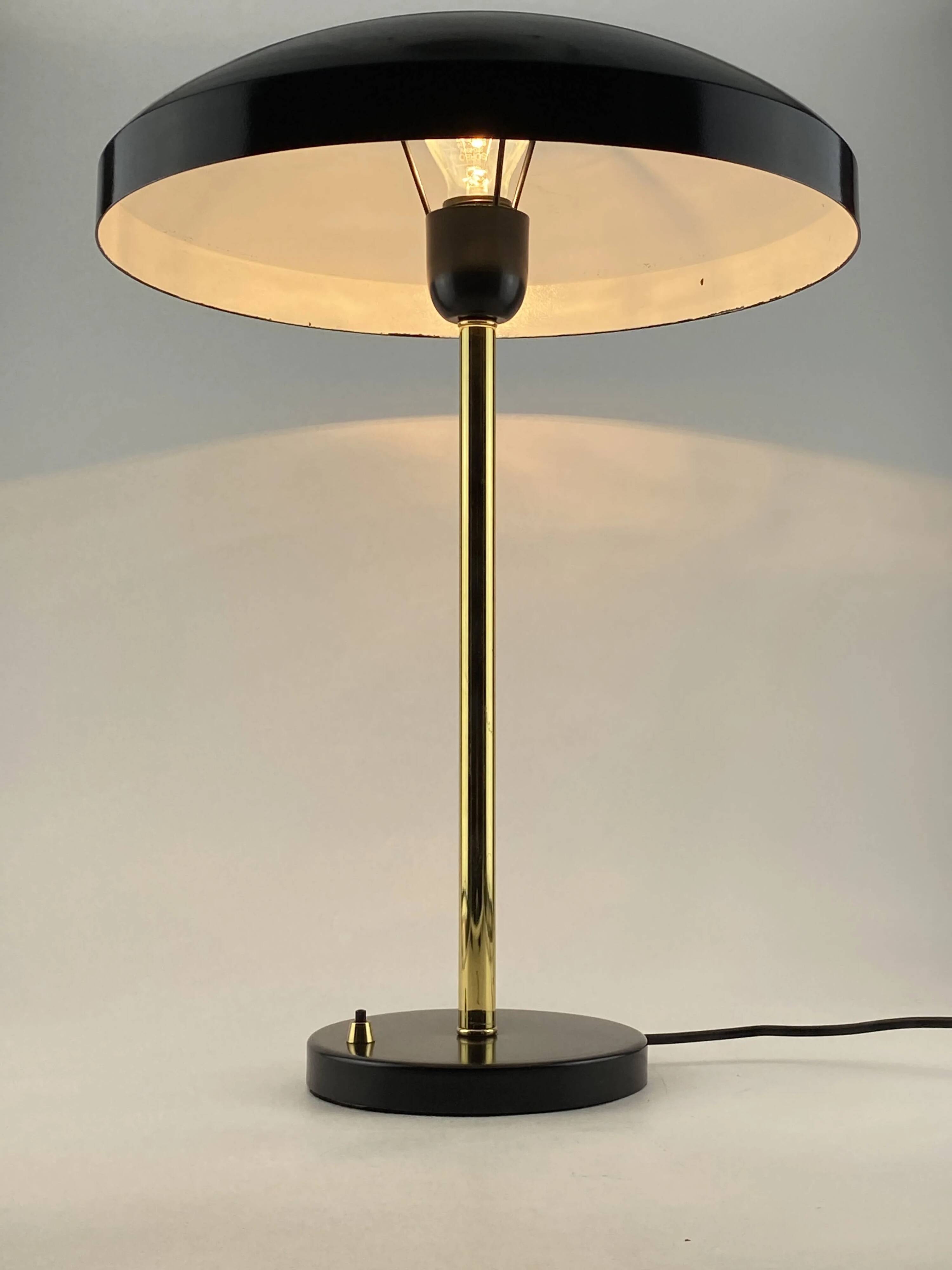 Rare black and gold UFO table lamp by Louis Kalff for Philips.