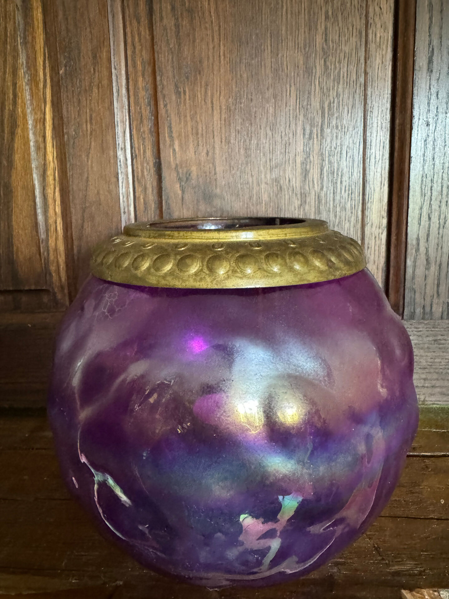 Antique iridescent purple glass lantern with a brass frame.