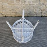 Round white rattan side table with storage underneath, circa 1970.