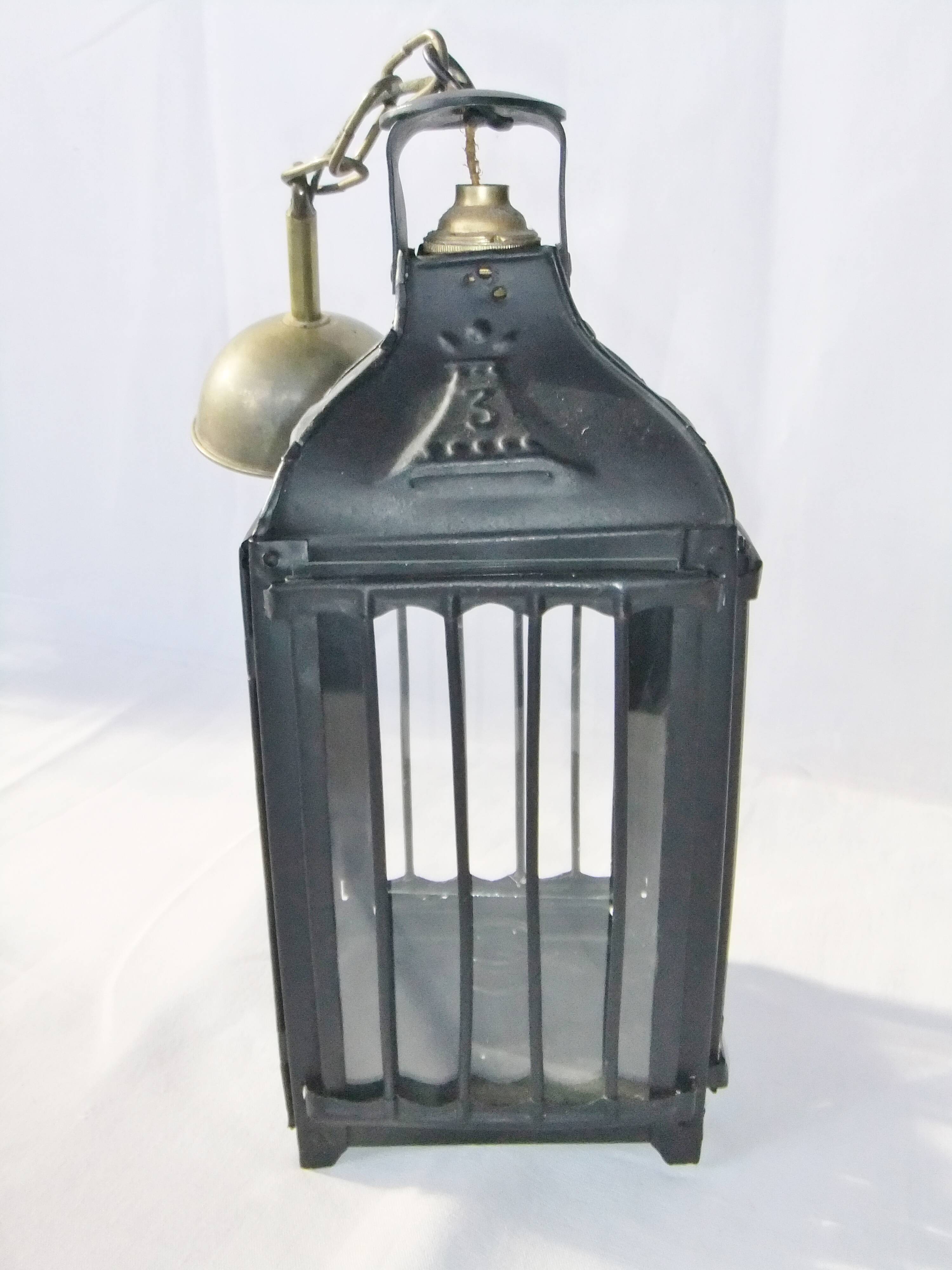 Old chandelier hanging lantern with candle in sheet metal