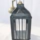 Old chandelier hanging lantern with candle in sheet metal
