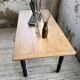 Oak farmhouse table with turned black legs.