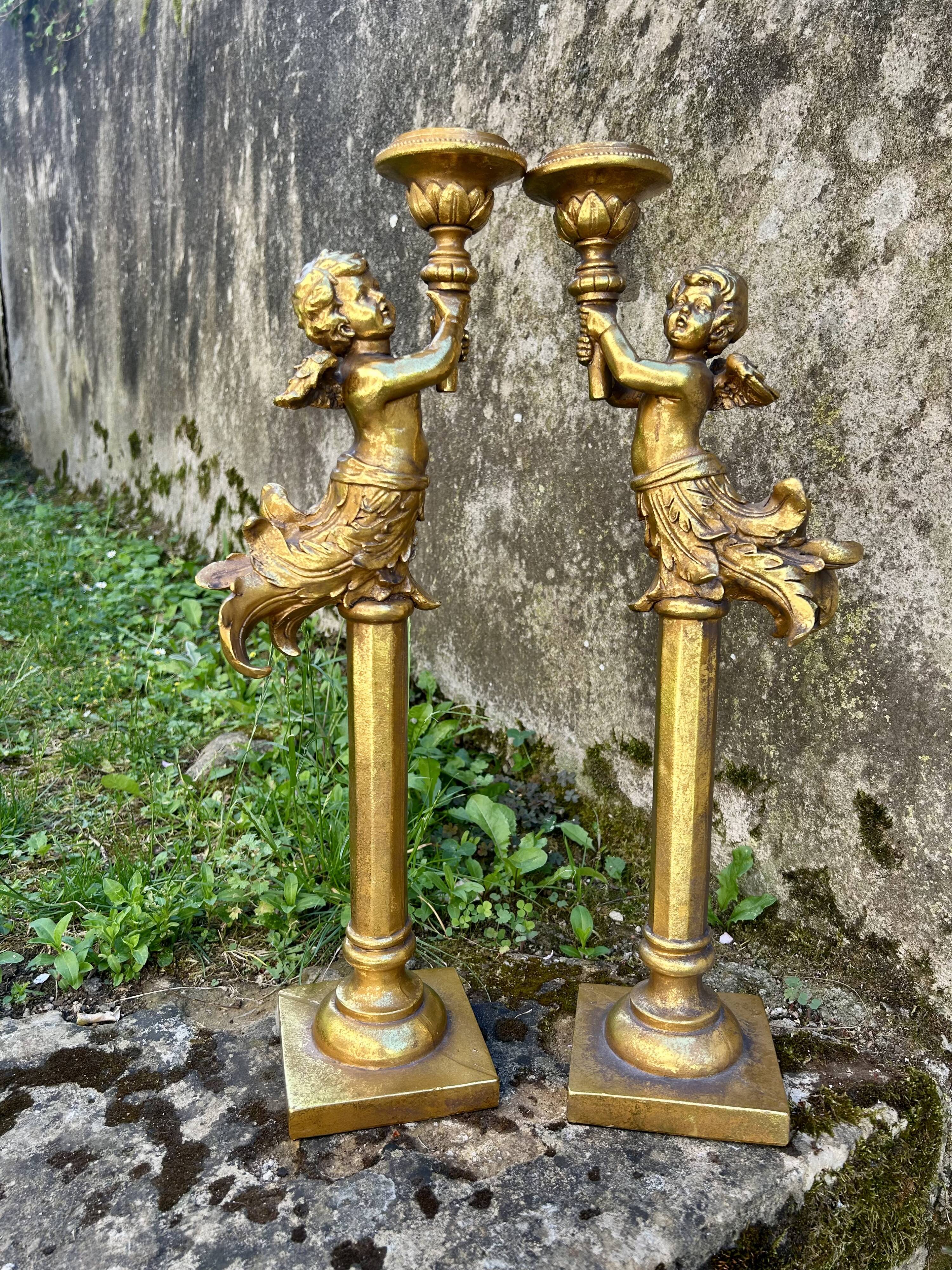 Pair of large candlesticks with cherubs