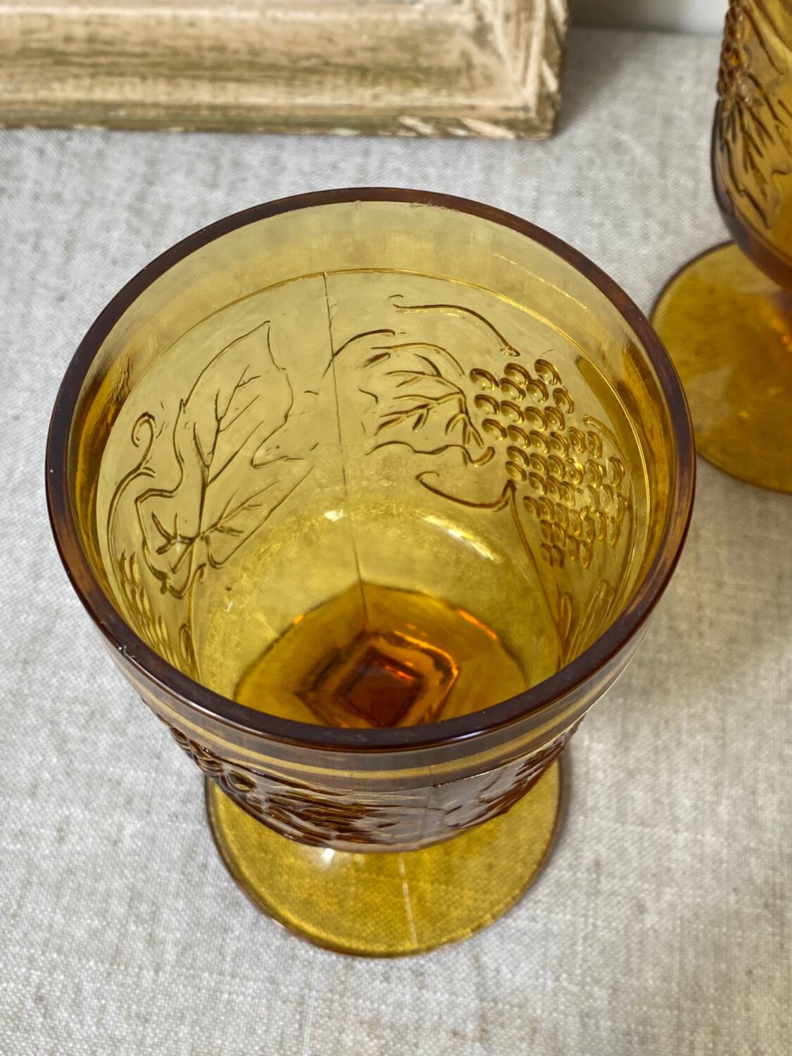 Six amber-colored stemmed glasses