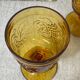 Six amber-colored stemmed glasses