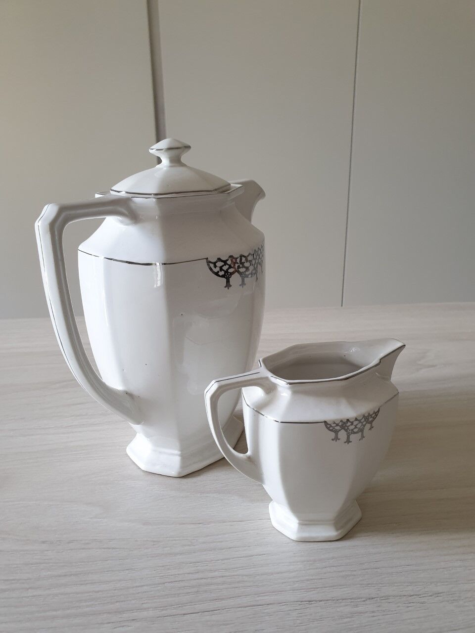 Old coffee maker and its milk pot