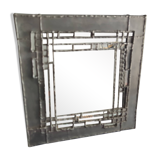 Tin mirror on brutalist wood support