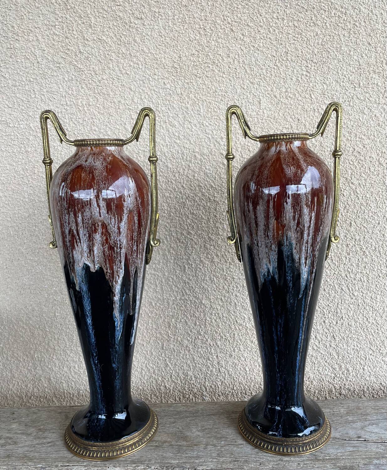 Two large stoneware vases with bronze fittings.
