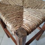 Antique campaign stool in solid wood with a straw seat.