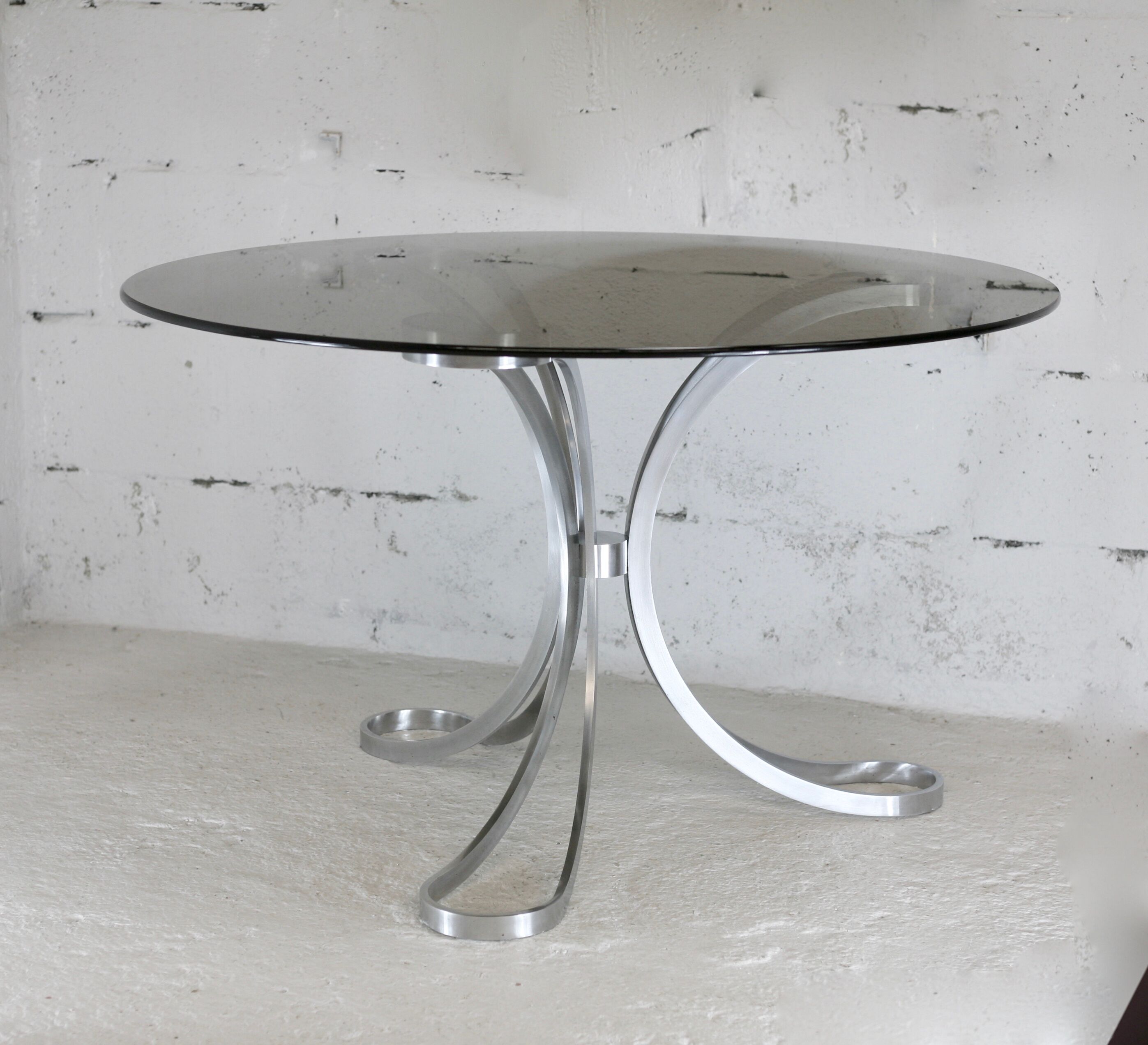 Living room table "Space Age" polished steel, circular slab smoked glass. France, circa 1970.