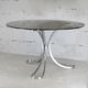 Table de séjour "Space Age" acier poli, dalle circulaire verre fumé. France, circa 1970.