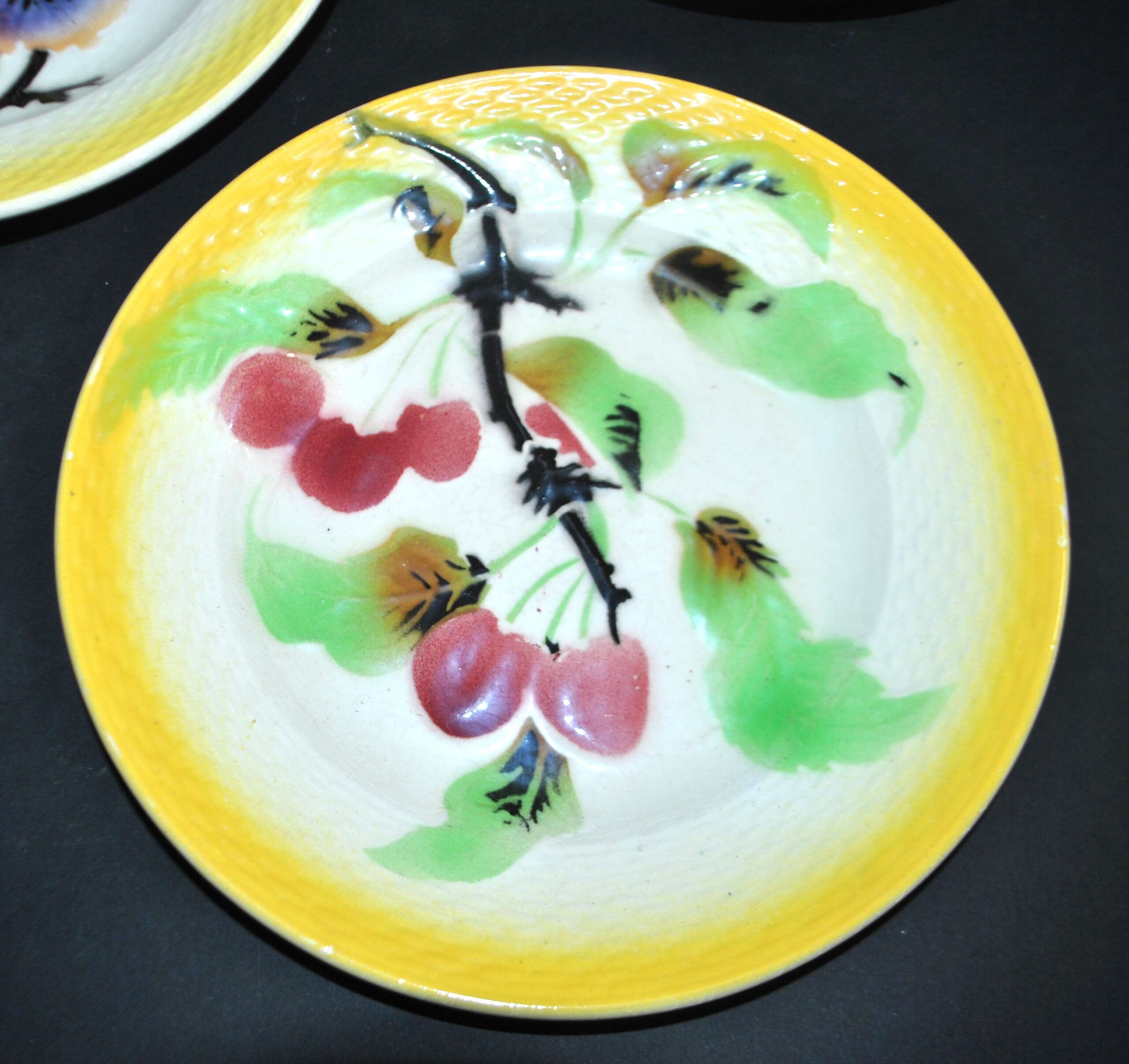 Orchies set of 6 yellow earthenware dessert plates with stencilled fruit decoration.