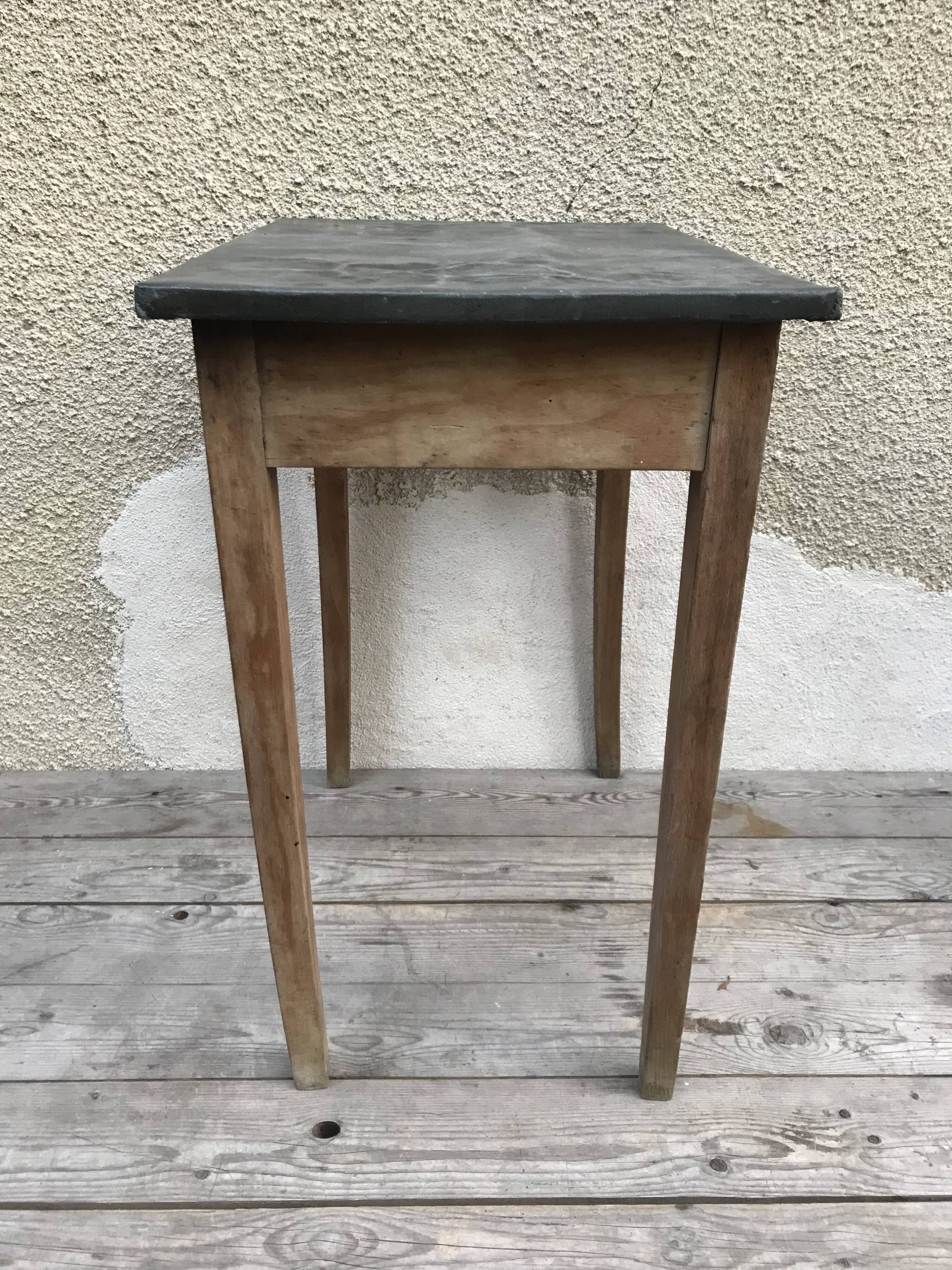 Old kitchen table in wood with compass feet