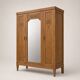 Art deco wardrobe in raw oak with bevelled mirror.