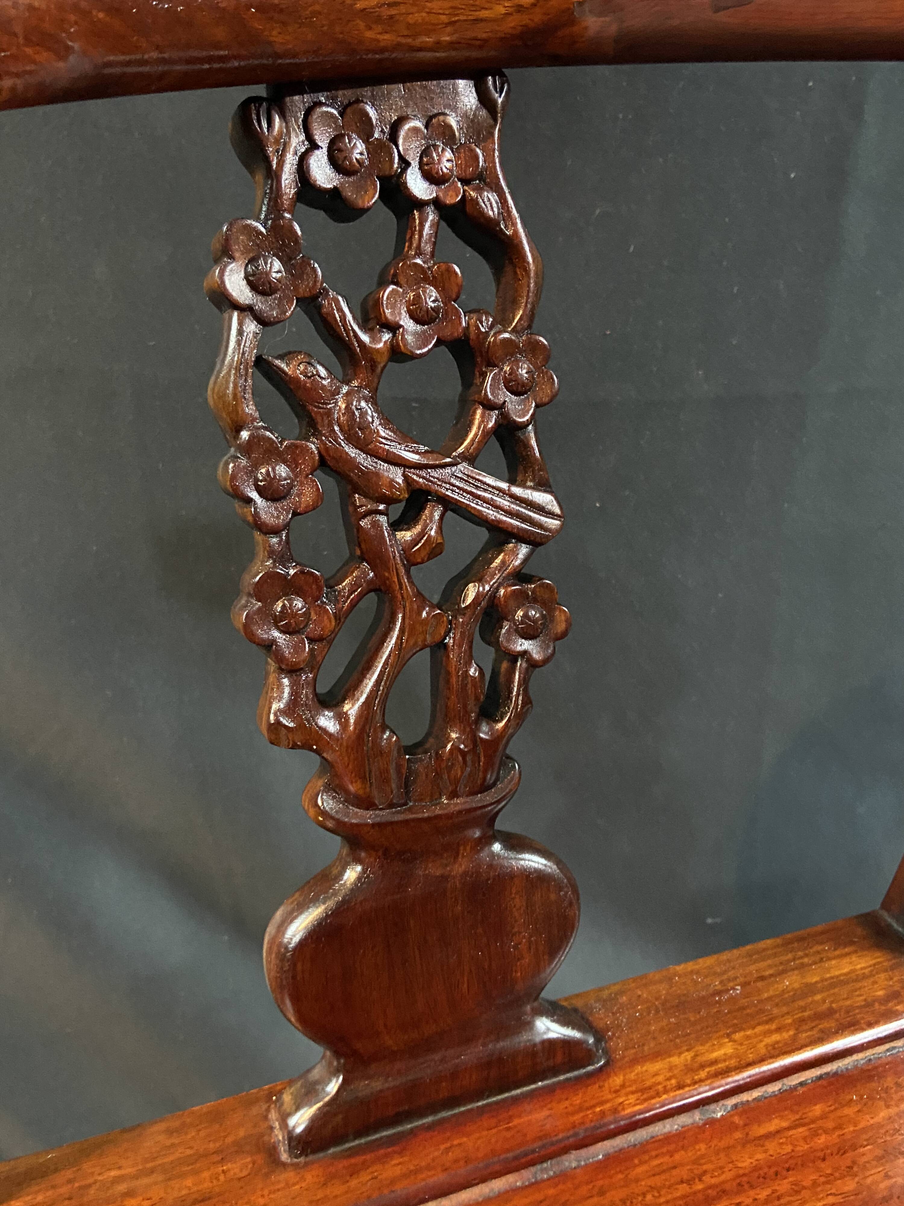 Corner armchair in solid wood with carved floral decoration featuring a bird.