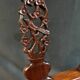 Corner armchair in solid wood with carved floral decoration featuring a bird.
