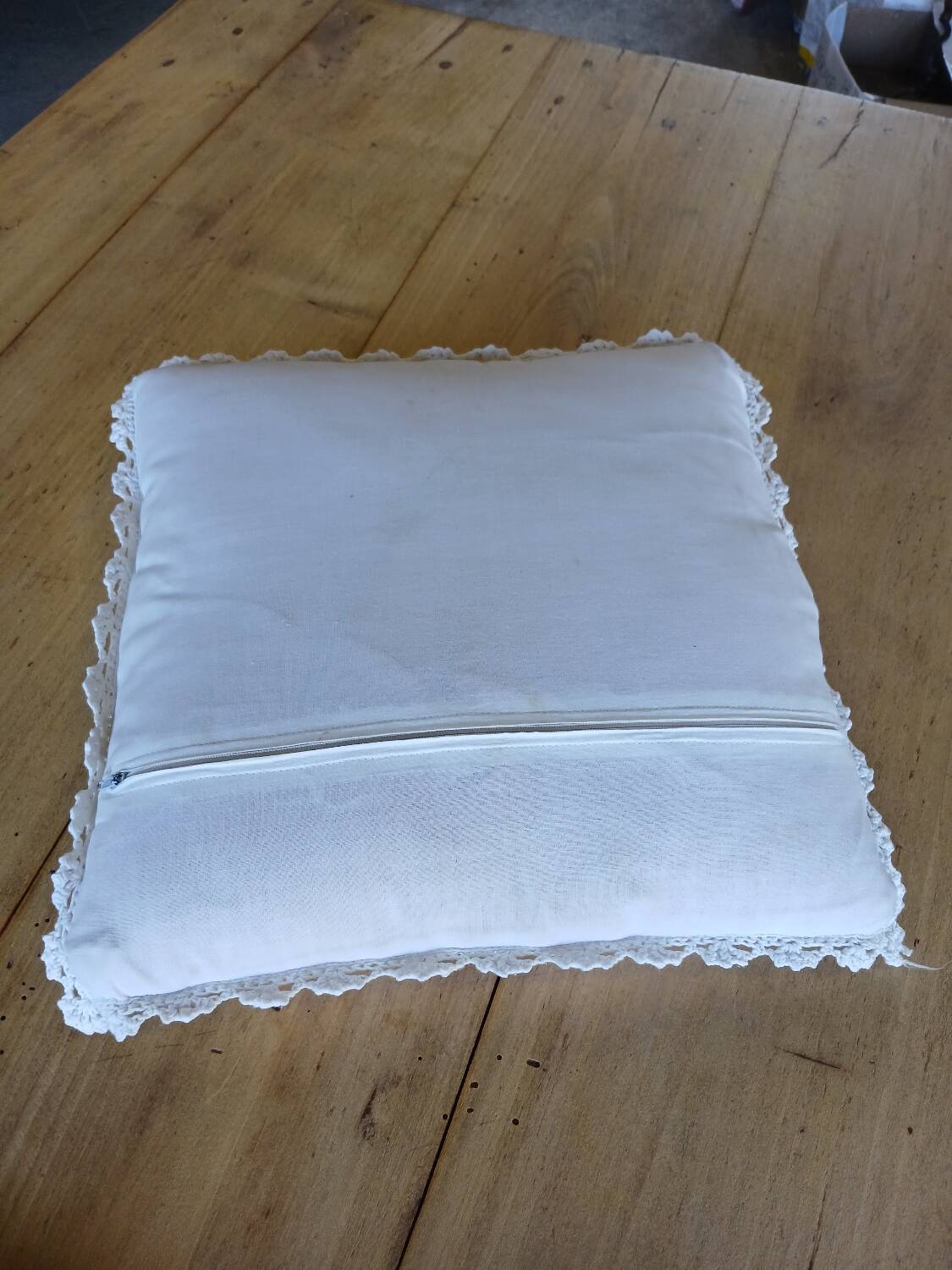 Cushion with white crochet cover