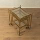Set of 3 vintage Hollywood Regency nesting tables with brass frame and glass tops (1960s)
