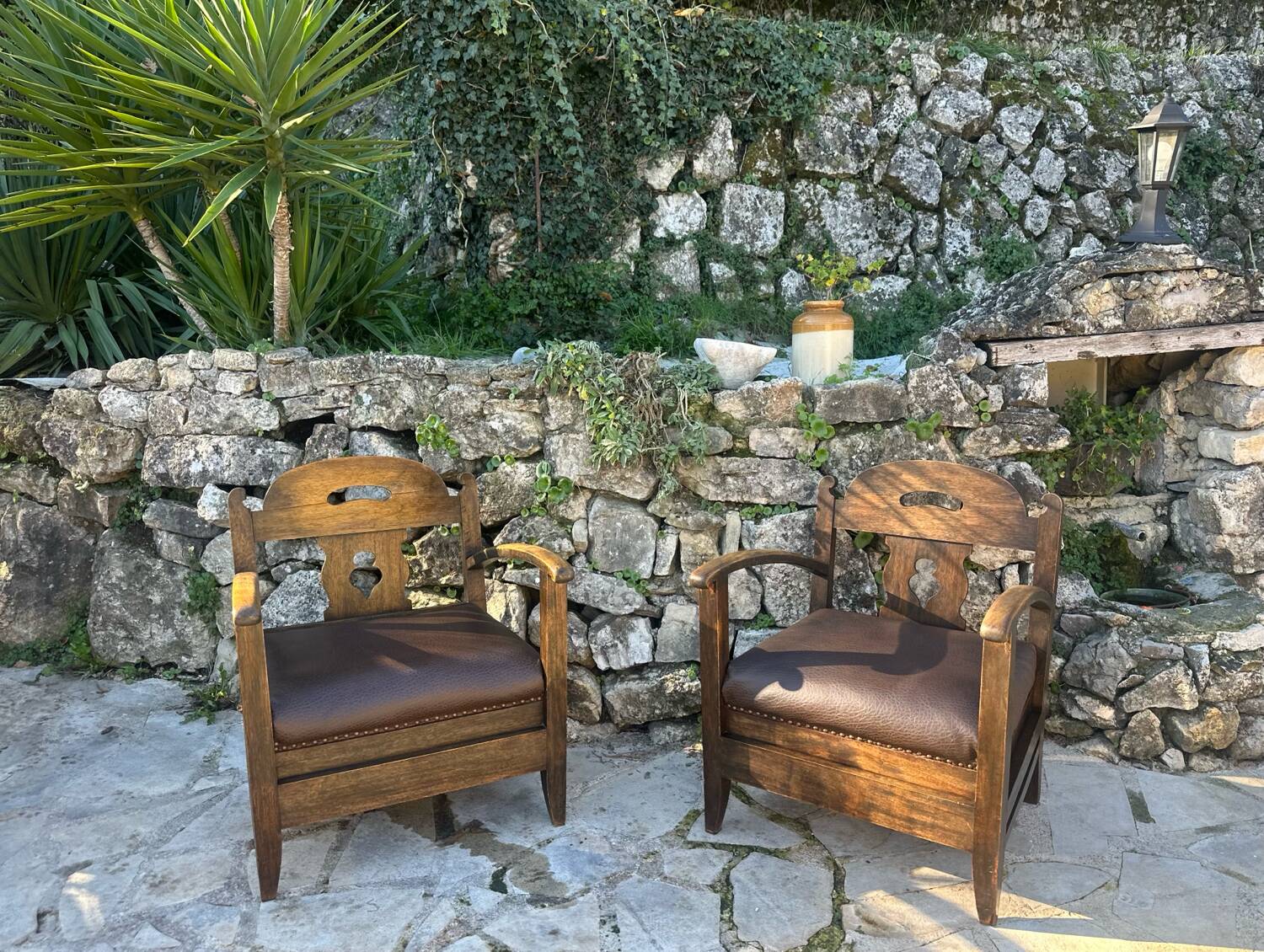 Pair of armchairs in stained wood and leather, 20th century