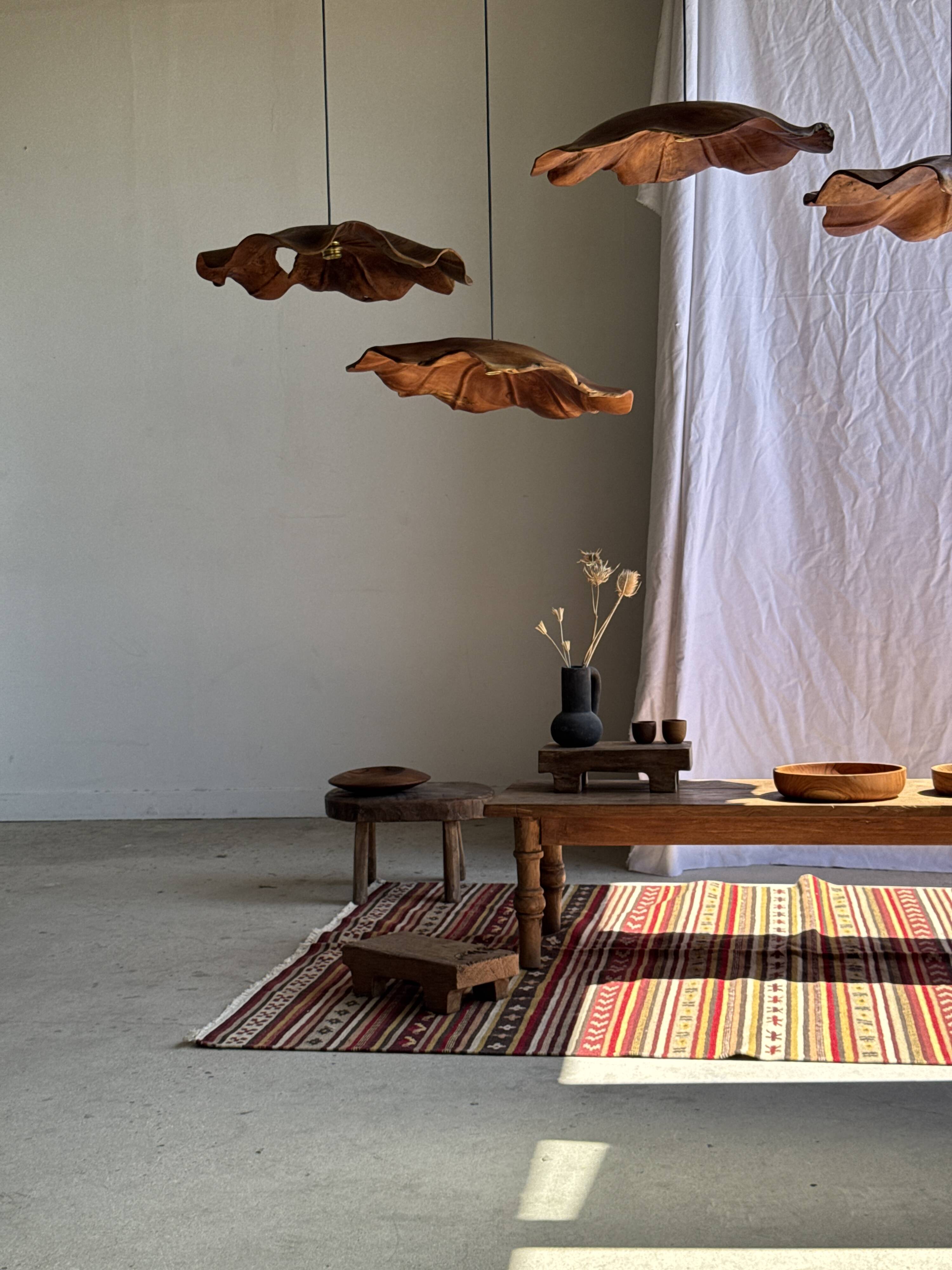 Large Indian rug with red, yellow, and white stripes and geometric fringes.
