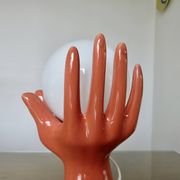 Pair of salmon-colored ceramic "hand" lamps with opaline globe, 80