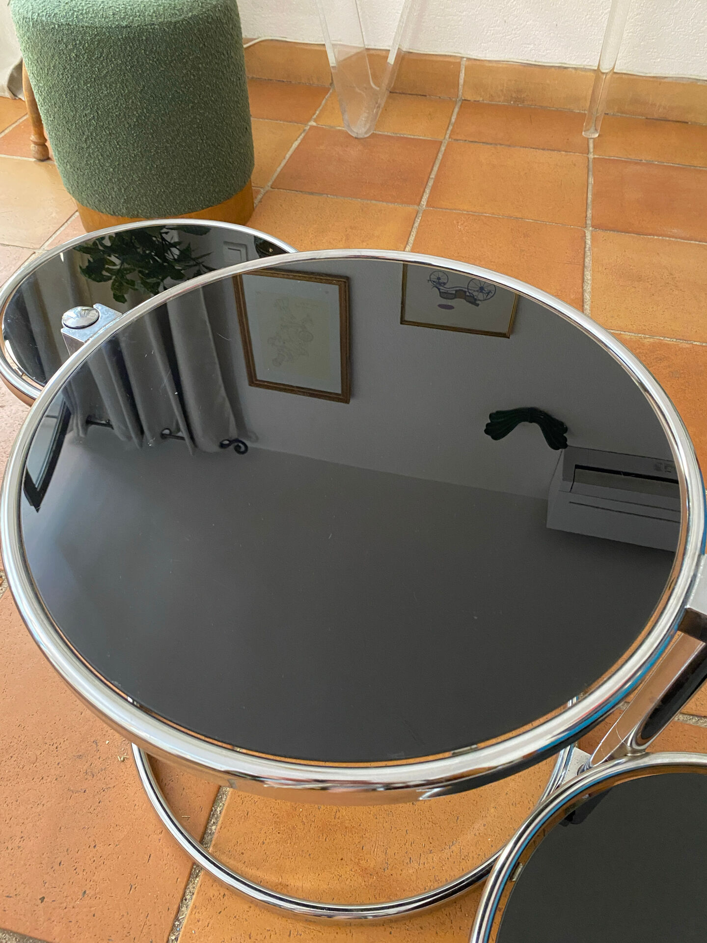 Coffee table with pivoting metal and black glass elements.