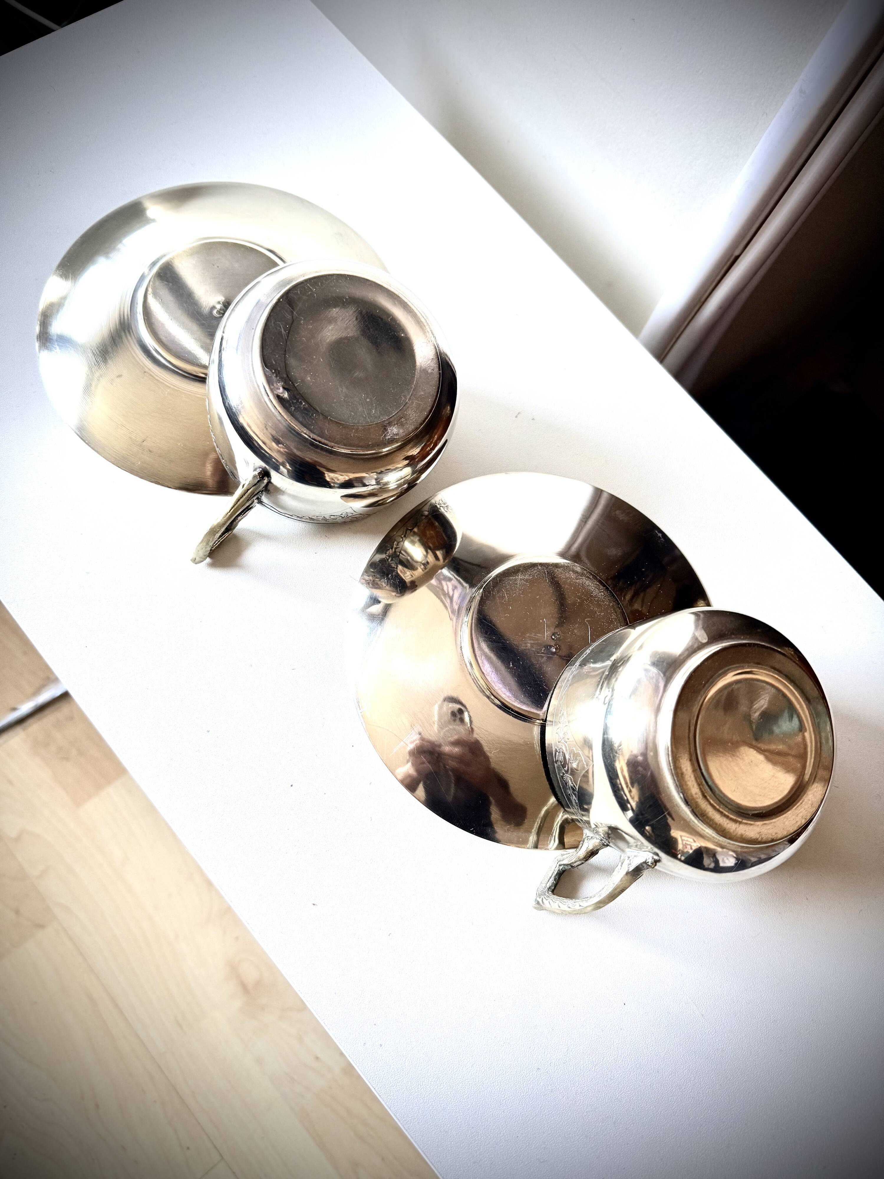 Set of 2 cups with silver-plated saucers, 19th century.