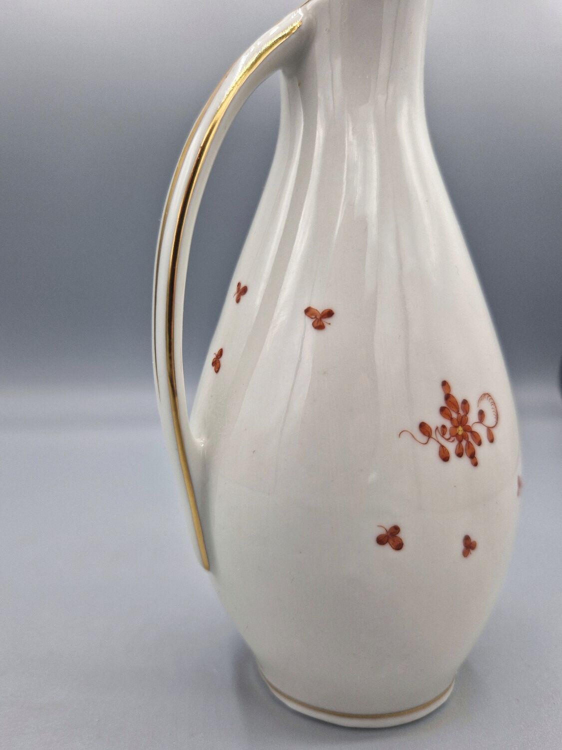 Hand painted German porcelain pitcher with floral design and gold trim