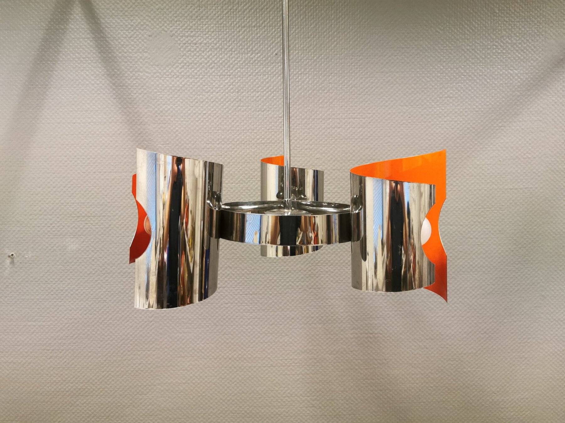 Hanging lamp in chromed metal with orange contrast lacquer and three light sources.