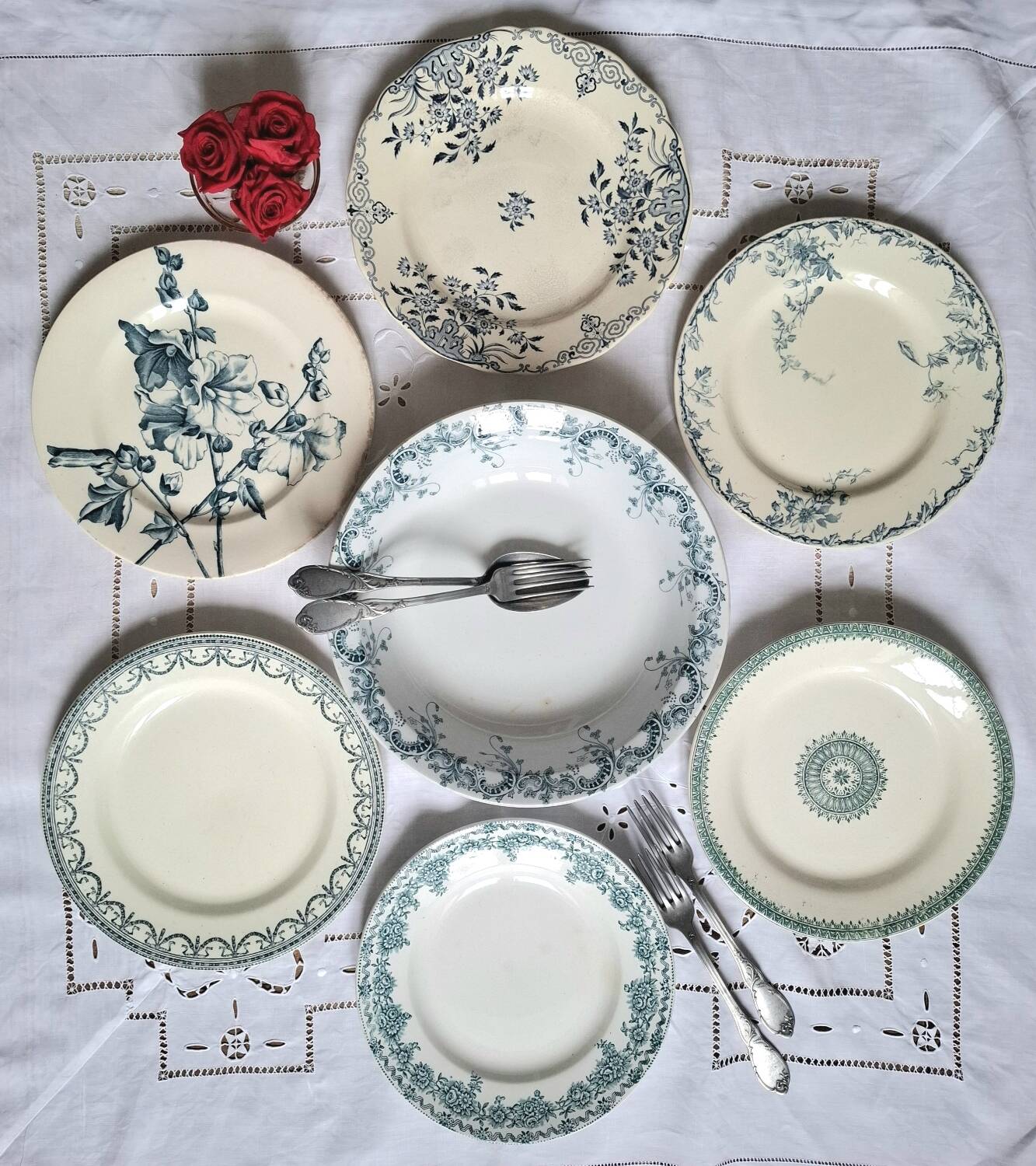 Old mismatched flat plates in iron earth earthenware accompanied by a dish